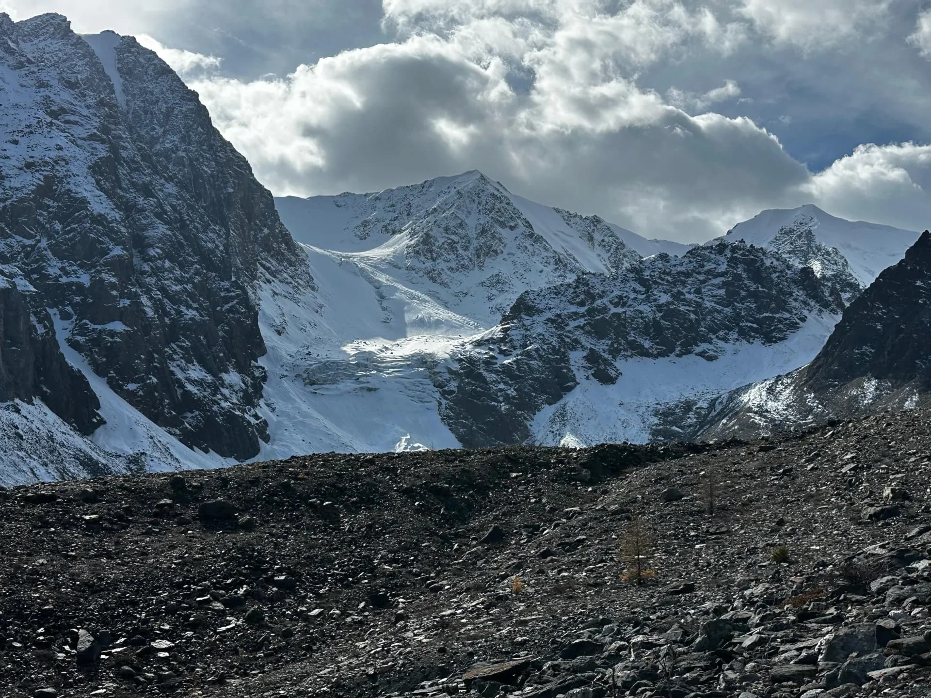 Glacial moraine valley beneath snow-covered Altai peaks